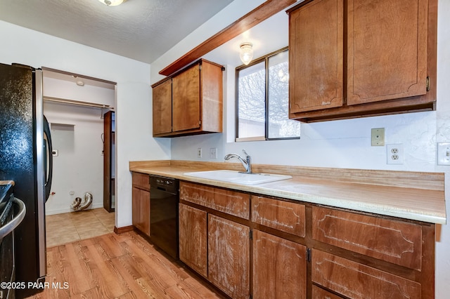 kitchen with sink, light hardwood / wood-style floors, dishwasher, and refrigerator