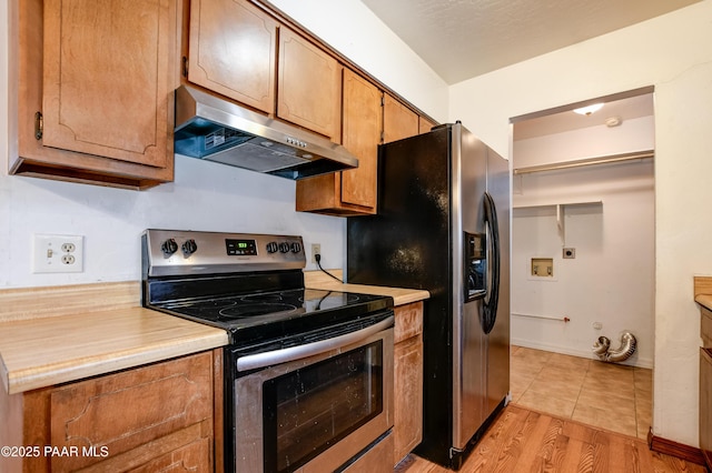 kitchen with stainless steel appliances and light wood-type flooring