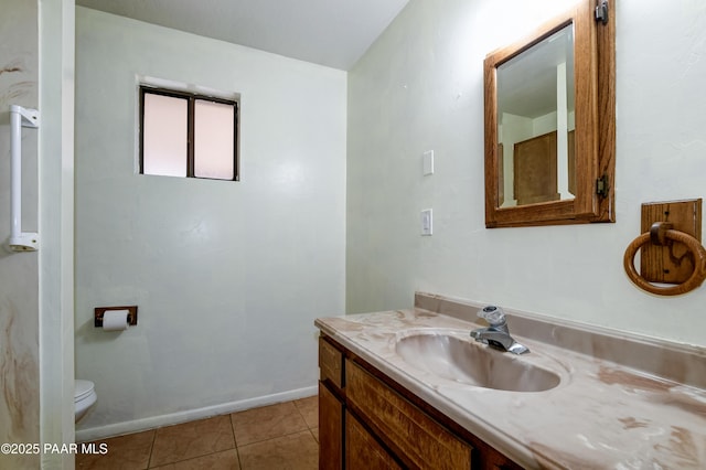 bathroom featuring tile patterned floors, vanity, and toilet