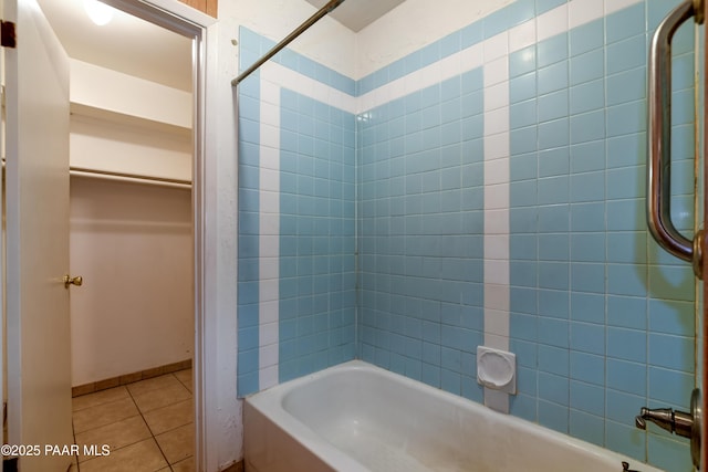 bathroom with tile patterned flooring and tiled shower / bath combo