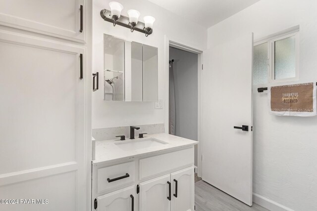 bathroom with vanity and hardwood / wood-style flooring