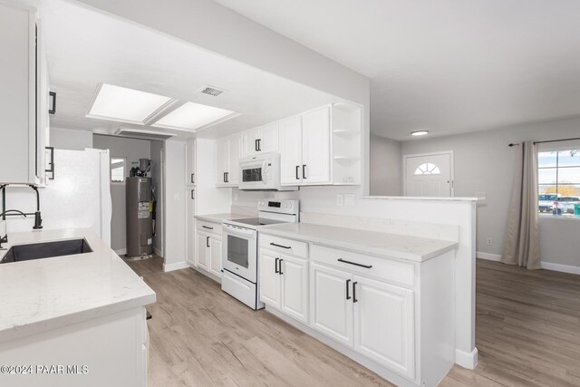 kitchen with white cabinets, white appliances, sink, and light hardwood / wood-style flooring