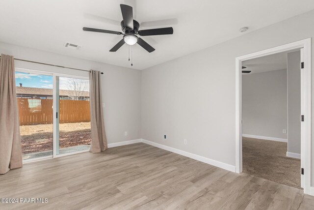 empty room featuring ceiling fan and light hardwood / wood-style flooring