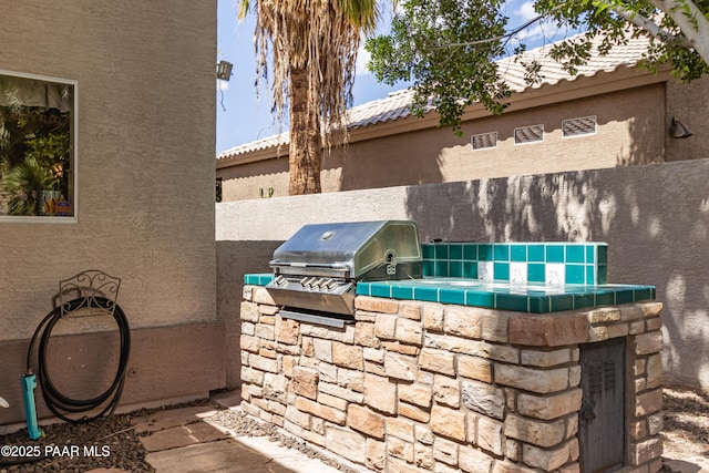 view of patio featuring grilling area and an outdoor kitchen