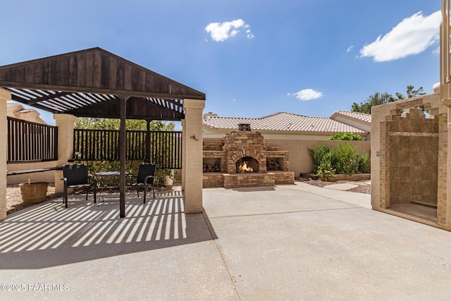 view of patio featuring fence and an outdoor stone fireplace