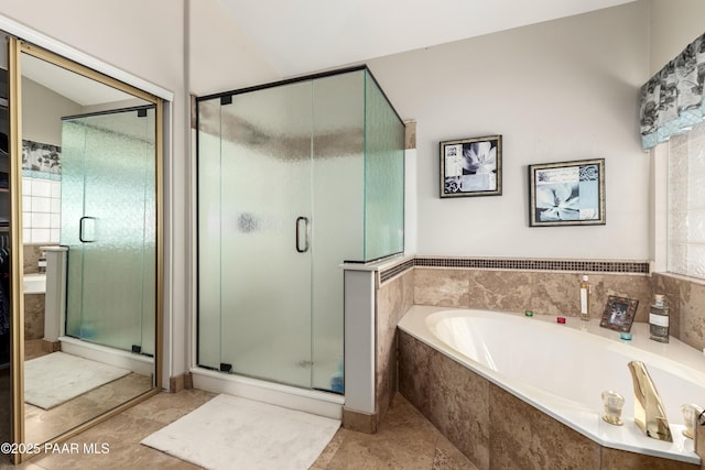 full bathroom with a bath and a stall shower