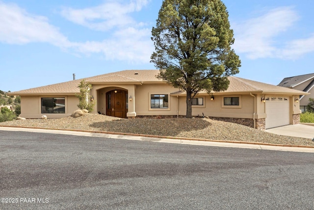783 N Creekside Dr, Prescott, AZ 86303 - view of front facade with a garage, concrete driveway, stucco siding, and stone siding