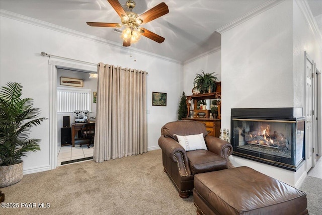 living area featuring light carpet, a multi sided fireplace, ceiling fan, and ornamental molding