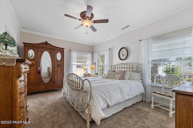 bedroom with ceiling fan, carpet flooring, and crown molding