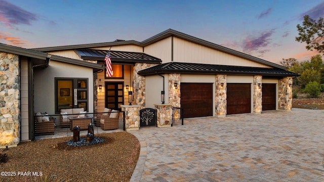 15425 N Talking Rock Ranch Rd, Prescott, AZ 86305 - view of front facade with stone siding, a standing seam roof, decorative driveway, an attached garage, and a metal roof