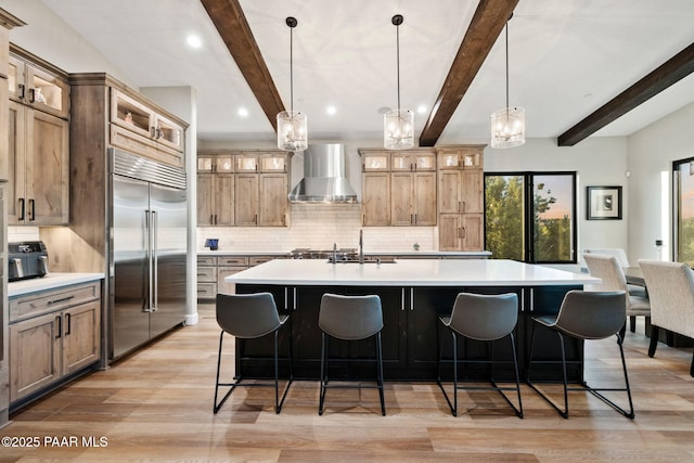 15425 N Talking Rock Ranch Rd, Prescott, AZ 86305 - kitchen featuring stainless steel built in fridge, wall chimney range hood, backsplash, a large island with sink, and light countertops