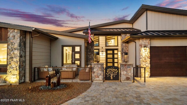 15425 N Talking Rock Ranch Rd, Prescott, AZ 86305 - view of front of property featuring stone siding, a standing seam roof, decorative driveway, and an attached garage
