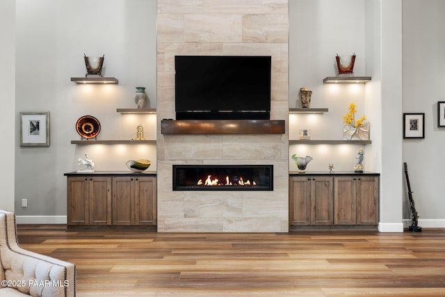 15425 N Talking Rock Ranch Rd, Prescott, AZ 86305 - living room featuring a tiled fireplace and wood finished floors