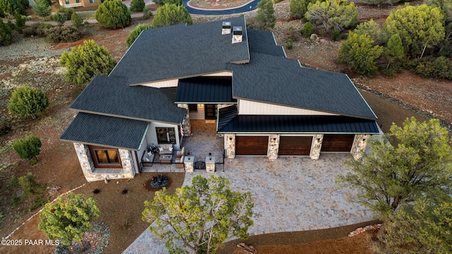 15425 N Talking Rock Ranch Rd, Prescott, AZ 86305 - view of front facade featuring stone siding, a standing seam roof, a metal roof, decorative driveway, and roof with shingles
