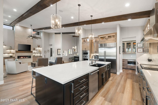 15425 N Talking Rock Ranch Rd, Prescott, AZ 86305 - kitchen with appliances with stainless steel finishes, wall chimney range hood, ceiling fan, beam ceiling, and decorative backsplash