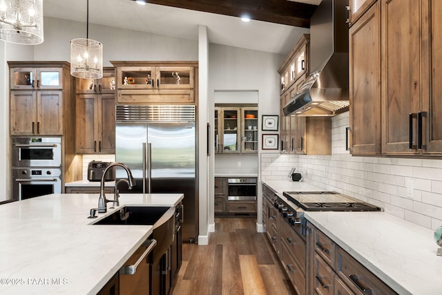 15425 N Talking Rock Ranch Rd, Prescott, AZ 86305 - kitchen with wall chimney exhaust hood, lofted ceiling, stainless steel appliances, dark wood-style flooring, and decorative light fixtures