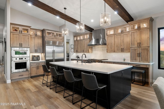15425 N Talking Rock Ranch Rd, Prescott, AZ 86305 - kitchen with wall chimney range hood, appliances with stainless steel finishes, light wood finished floors, decorative backsplash, and recessed lighting