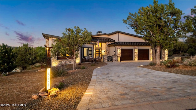 15425 N Talking Rock Ranch Rd, Prescott, AZ 86305 - contemporary house featuring stone siding, a standing seam roof, a garage, decorative driveway, and a metal roof