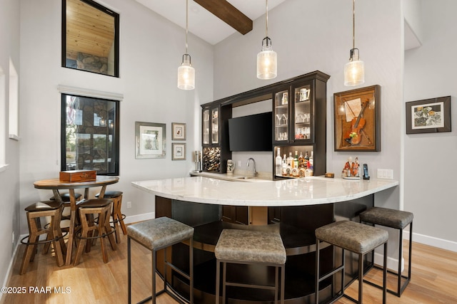 15425 N Talking Rock Ranch Rd, Prescott, AZ 86305 - indoor wet bar with high vaulted ceiling, light wood-type flooring, pendant lighting, and beam ceiling