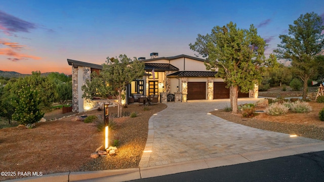 15425 N Talking Rock Ranch Rd, Prescott, AZ 86305 - contemporary home with decorative driveway, a standing seam roof, an attached garage, a metal roof, and stone siding