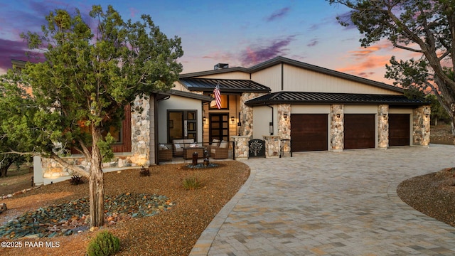 15425 N Talking Rock Ranch Rd, Prescott, AZ 86305 - view of front of property featuring a standing seam roof, stone siding, decorative driveway, a garage, and a metal roof