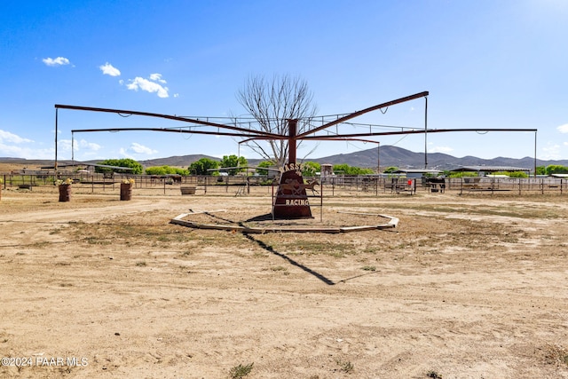 view of jungle gym with a mountain view and a rural view