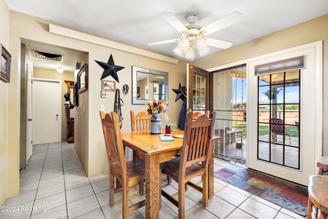 tiled dining room with ceiling fan