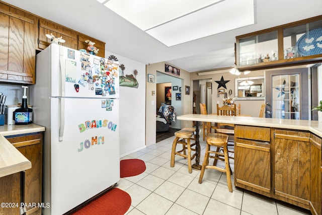 kitchen featuring white refrigerator and light tile patterned floors