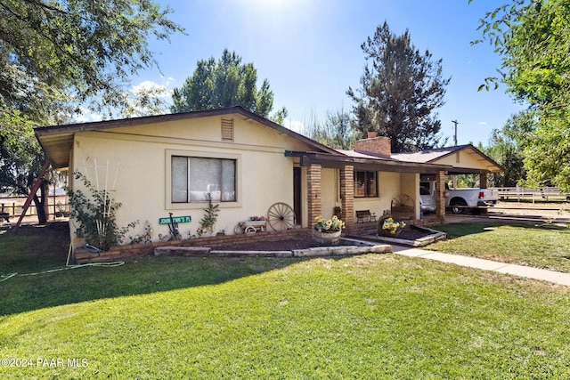 ranch-style home featuring a front yard