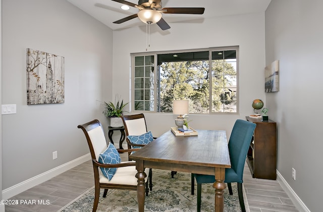 dining area with light wood-style floors, baseboards, and ceiling fan