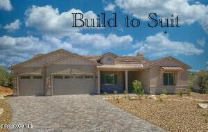 view of front facade featuring an attached garage and decorative driveway