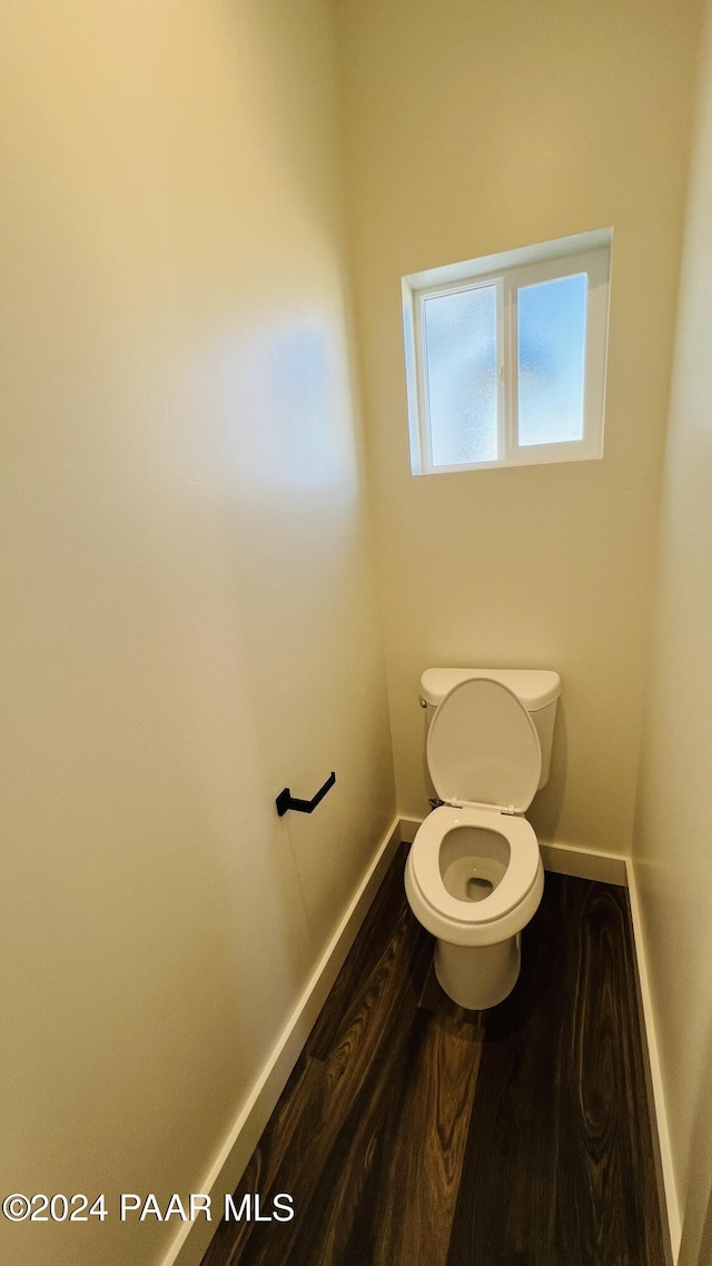 bathroom featuring hardwood / wood-style floors and toilet