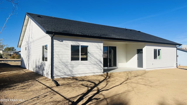 back of property with a patio