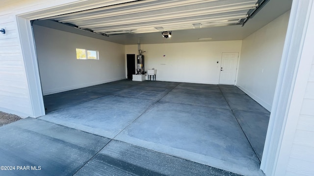 garage featuring a garage door opener and water heater