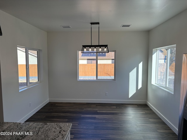 unfurnished dining area with dark hardwood / wood-style floors