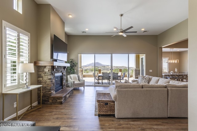 5220 Peavine View Trl, Prescott, AZ 86301 - living room featuring visible vents, a stone fireplace, dark wood-type flooring, recessed lighting, and ceiling fan with notable chandelier