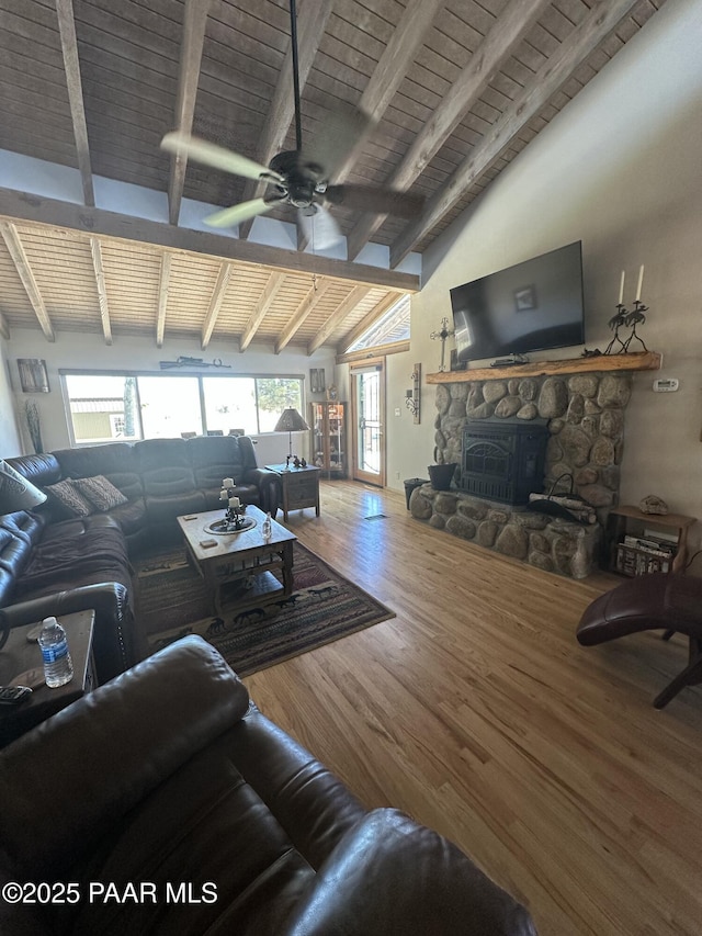 13502 S Burton Rd, Mayer, AZ 86333 - living area with wood finished floors, a wooden ceiling with exposed beams, a stone fireplace, ceiling fan, and high vaulted ceiling
