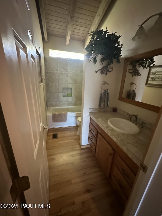 13502 S Burton Rd, Mayer, AZ 86333 - bathroom with vanity, wood finished floors, a wood ceiling with exposed beams, and shower / tub combination