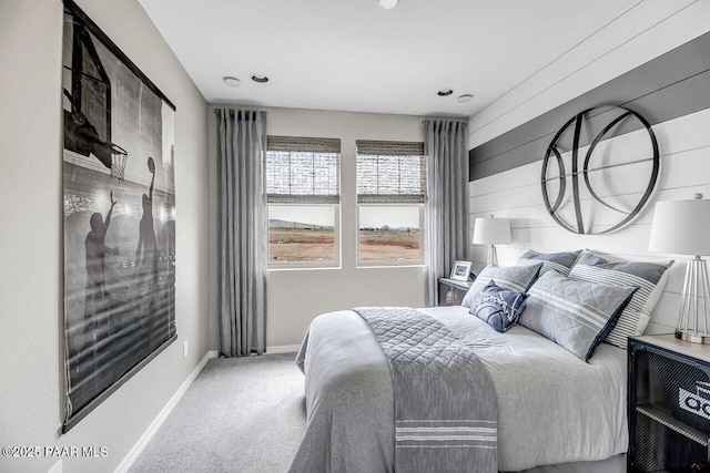 bedroom with carpet flooring and wooden walls