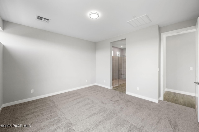 interior space featuring carpet flooring, baseboards, and visible vents