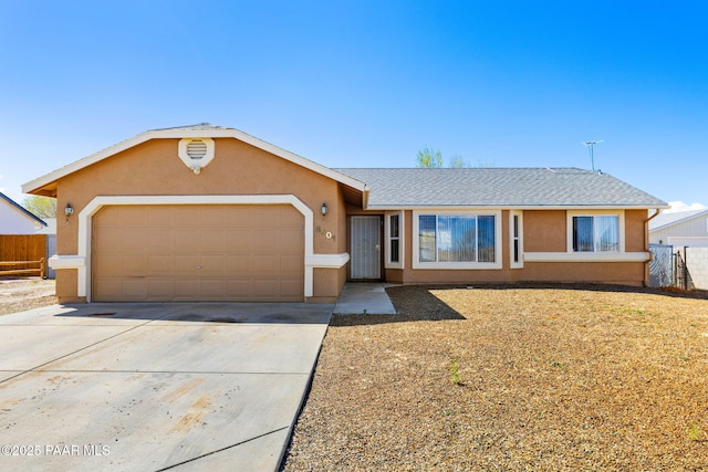 single story home with driveway, stucco siding, fence, and an attached garage