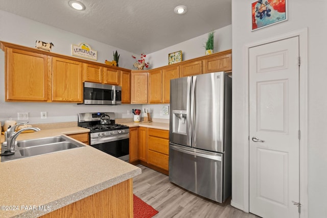 983 N Rolling Green Rd, Dewey-Humboldt, AZ 86327 - kitchen featuring appliances with stainless steel finishes, light countertops, light wood-style floors, recessed lighting, and brown cabinets