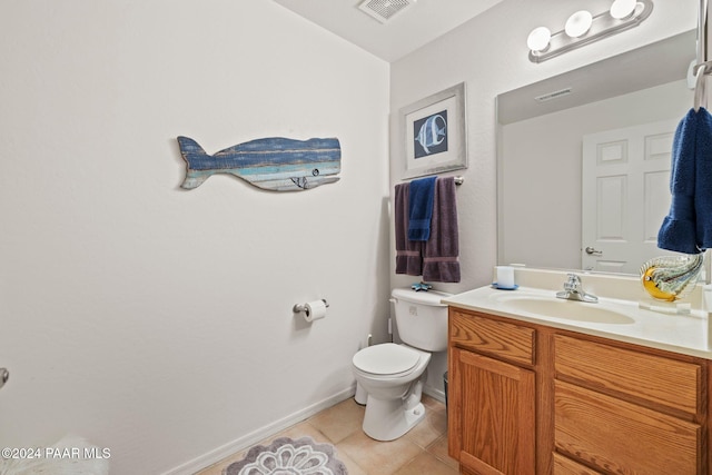 bathroom with tile patterned flooring, vanity, and toilet