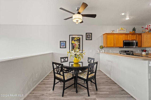 dining area featuring ceiling fan and light wood-type flooring