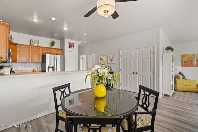 dining space featuring ceiling fan and light wood-type flooring