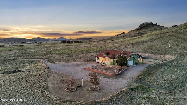 16025 N Hereford Rd, Chino Valley, AZ 86323 - yard at dusk with a mountain view, gravel driveway, and a view of rural / pastoral area