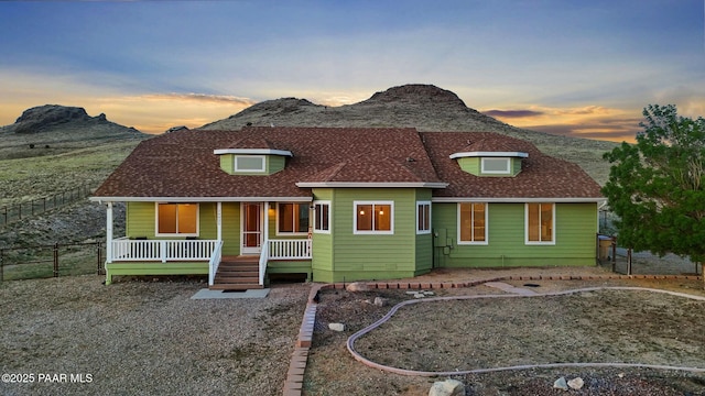 16025 N Hereford Rd, Chino Valley, AZ 86323 - view of front of home with a mountain view, a shingled roof, and covered porch