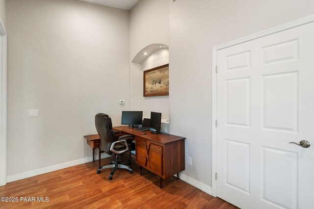 16025 N Hereford Rd, Chino Valley, AZ 86323 - office space featuring light wood-style flooring, baseboards, and a towering ceiling