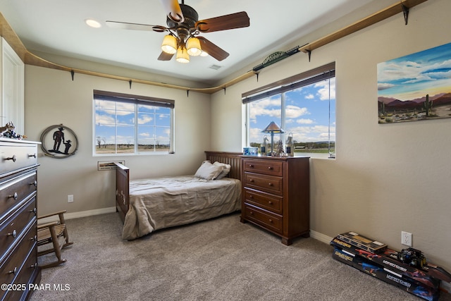 bedroom with baseboards, a ceiling fan, carpet, and visible vents