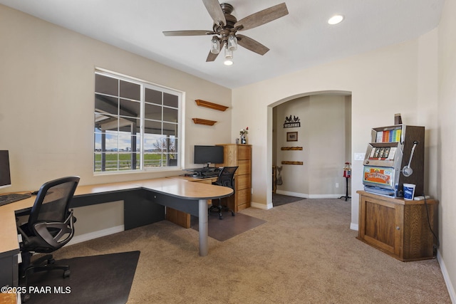 home office featuring carpet flooring, ceiling fan, arched walkways, recessed lighting, and baseboards